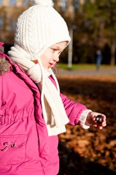 cute littloe girl playing outdoor in colorfull autumn park