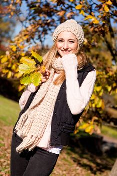 young woman in autumn sunshine outdoor in warm clothes lifestyle