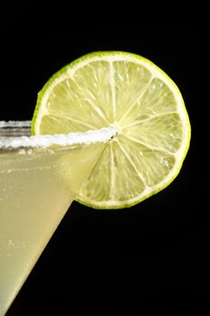 close-up of cocktail with lemon on a black background