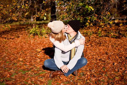 happy young couple smilin in colorful sunny autumn outdoor in park