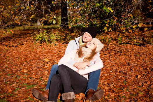 happy young couple smilin in colorful sunny autumn outdoor in park