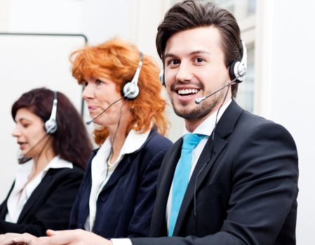 smiling callcenter agent with headset support hotline