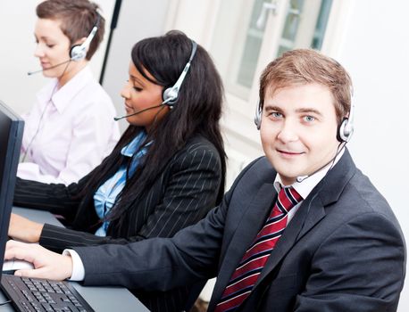 smiling callcenter agent with headset support hotline