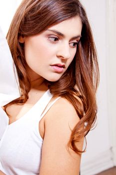 beautiful brunette woman in sunlight at window looking sensual portrait 