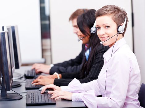 smiling callcenter agent with headset support hotline