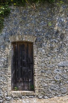 Old weathered doors on stone wall. Near Saint Paul, Provence, France.