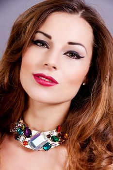 attractive brunette woman with glamour jewellry and make up portrait