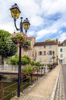 Village street with bridges over brook chanel, France.