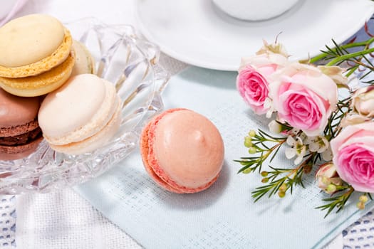 traditional delicious sweet dessert macarons and coffee on table