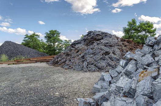 Scrapheap with metal waste piles ready to be recycled.