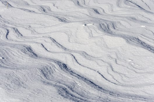 Snow pattern formed by blowing wind.