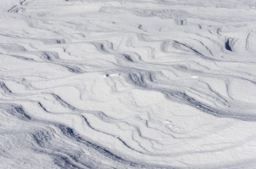Snow pattern formed by blowing wind.