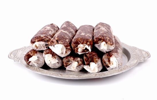 Homemade cake "sausage" in tracing the aluminum tray on a white background