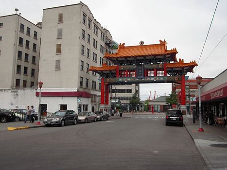 A photograph of a gateway to a Asian cultural district detailing its unique structure and design.