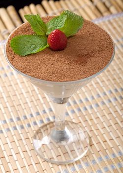 Delicious tiramisu cake in a glass vase.