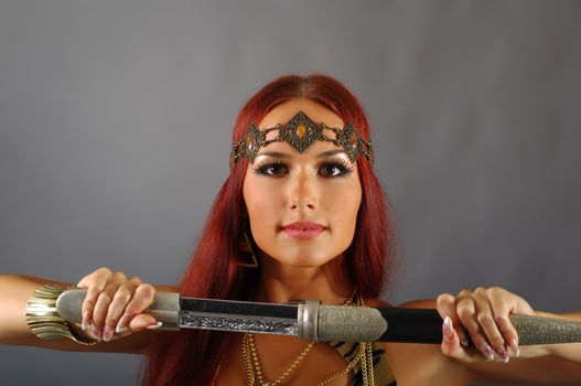 young warrior woman holding sword in her hand