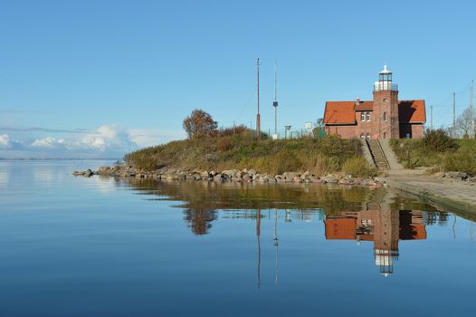 old lighthouse and its reflection in the sea