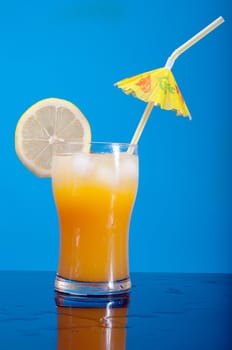 tropical cold cocktail  closeup on blue background.