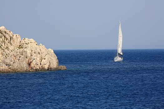 big sailing boat in the blue water of a greek island