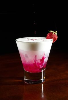 glass of cocktail with vodka gin milk and grenadine