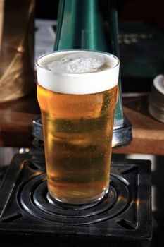 close up of glass with beer placed at the bar