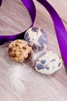 easter decoration with quail eggs on wooden background