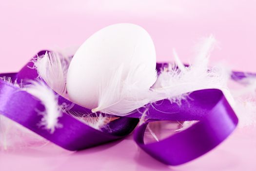 festive traditional easter egg decoration purple satin ribbon on pink 