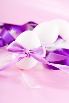 festive traditional easter egg decoration purple satin ribbon on pink 