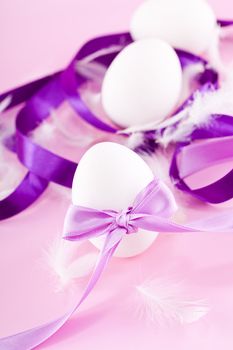 festive traditional easter egg decoration purple satin ribbon on pink 