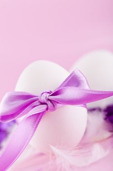 festive traditional easter egg decoration purple satin ribbon on pink 