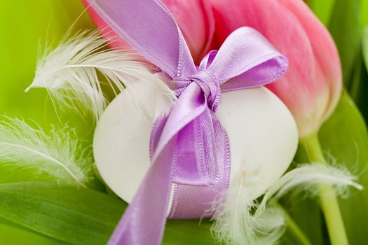 traditional easter egg decoration with tulips and ribbon green background 