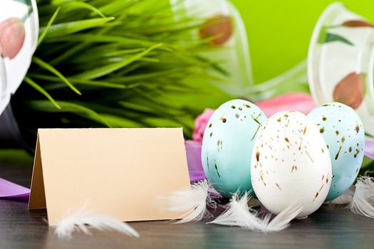 traditional easter egg decoration with tulips and ribbo and feather
