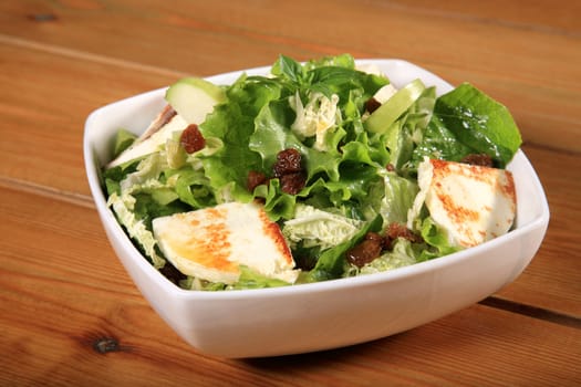 close up of a green salad with cheese and green apple