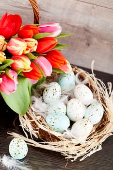 festive traditional easter egg decoration ribbon and tulips on wooden background