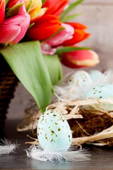 festive traditional easter egg decoration ribbon and tulips on wooden background