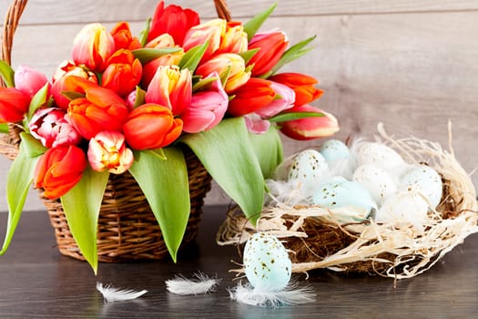 festive traditional easter egg decoration ribbon and tulips on wooden background