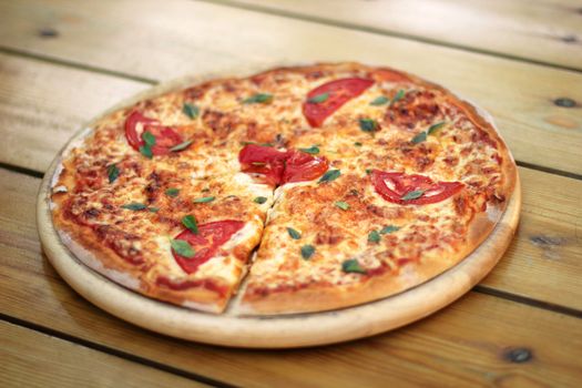 fresh pizza margarita on a wooden plate selective focus