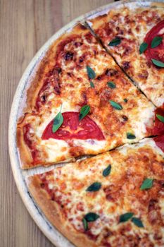 fresh pizza margarita on a wooden plate selective focus