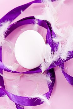 festive traditional easter egg decoration purple satin ribbon on pink 
