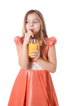 Portrait of happy little girl drinking orange juice