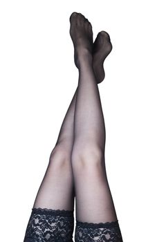 Close up view of woman`s legs while she put on her black lingerie isolated over white background
