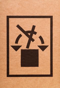 Handle with care sign on a cardboard box
