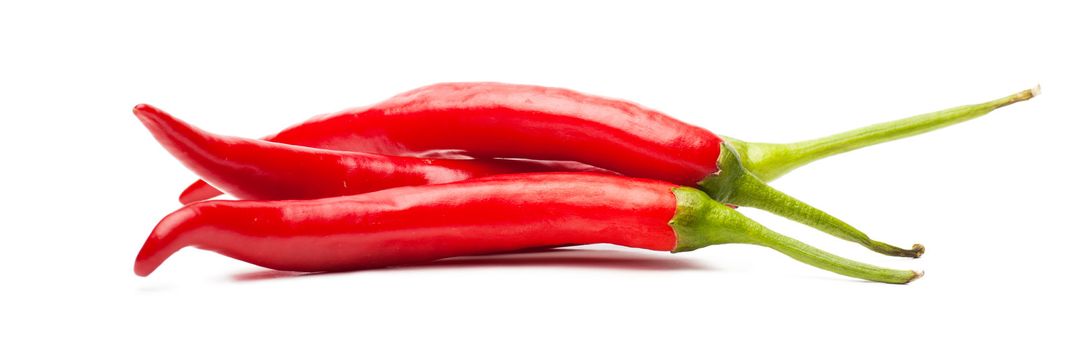 Closeup view of red chili peppers isolated over white background