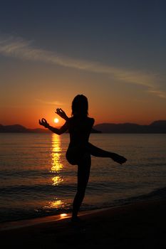 silhouette of a dancer in a beautiful beach at the sunset