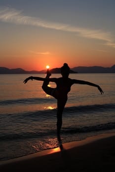 silhouette of a dancer in a beautiful beach at the sunset