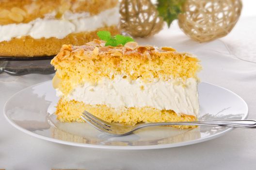 flat cake with an almond and sugar coating and a custard or cream filling