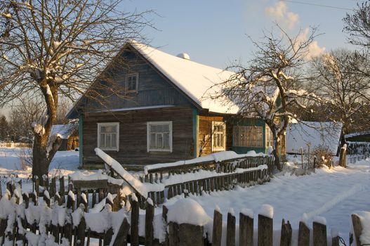 wooden house in winter forest