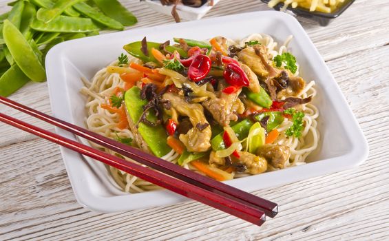 Noodles with pork and vegetables in plum sauce