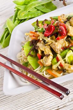 Noodles with pork and vegetables in plum sauce