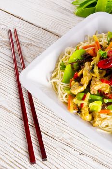 Noodles with pork and vegetables in plum sauce